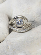 Spiky engagement and wedding ring set on stone background