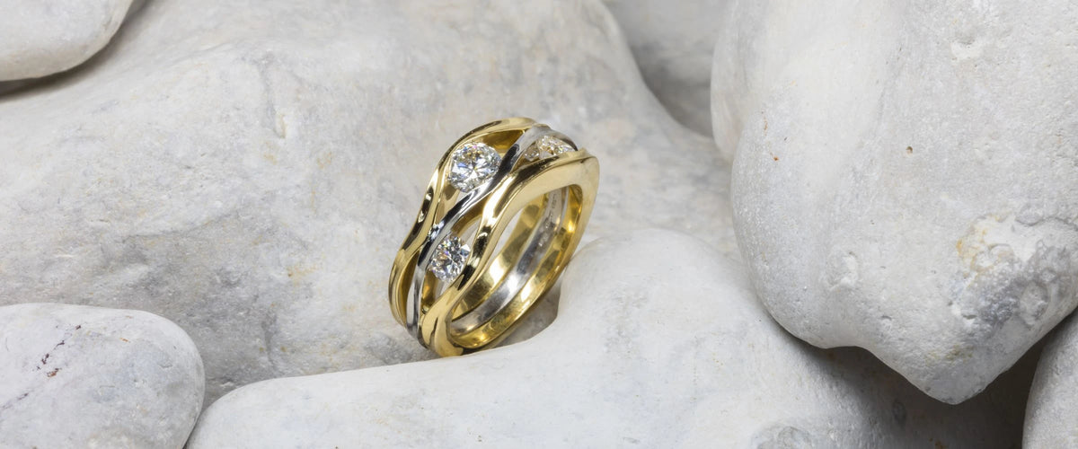 Mixed metal ring on stone background