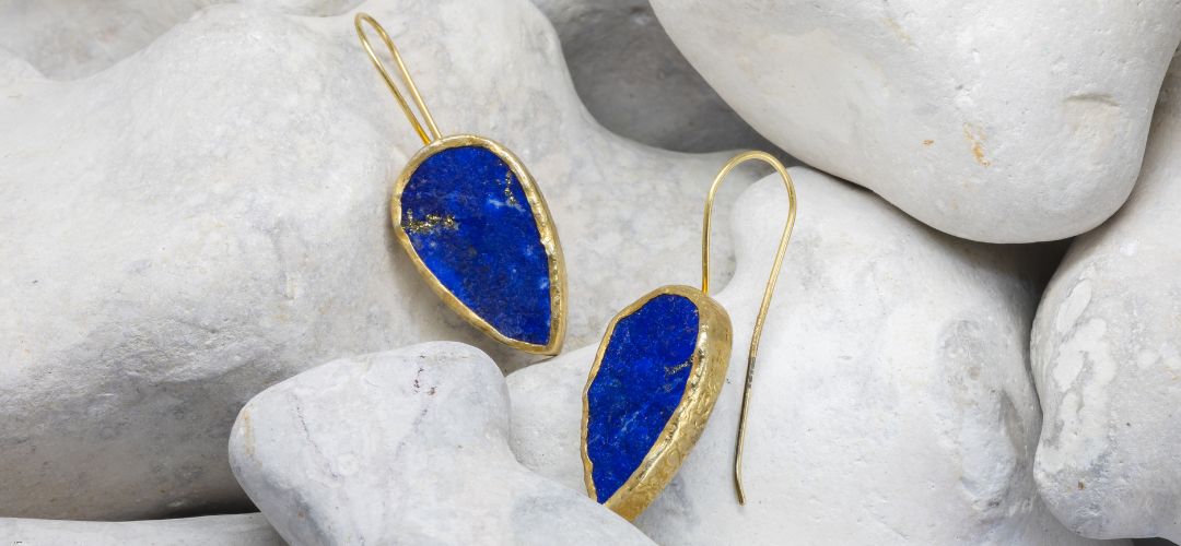 Lapis lazuli drop earrings on a rock background