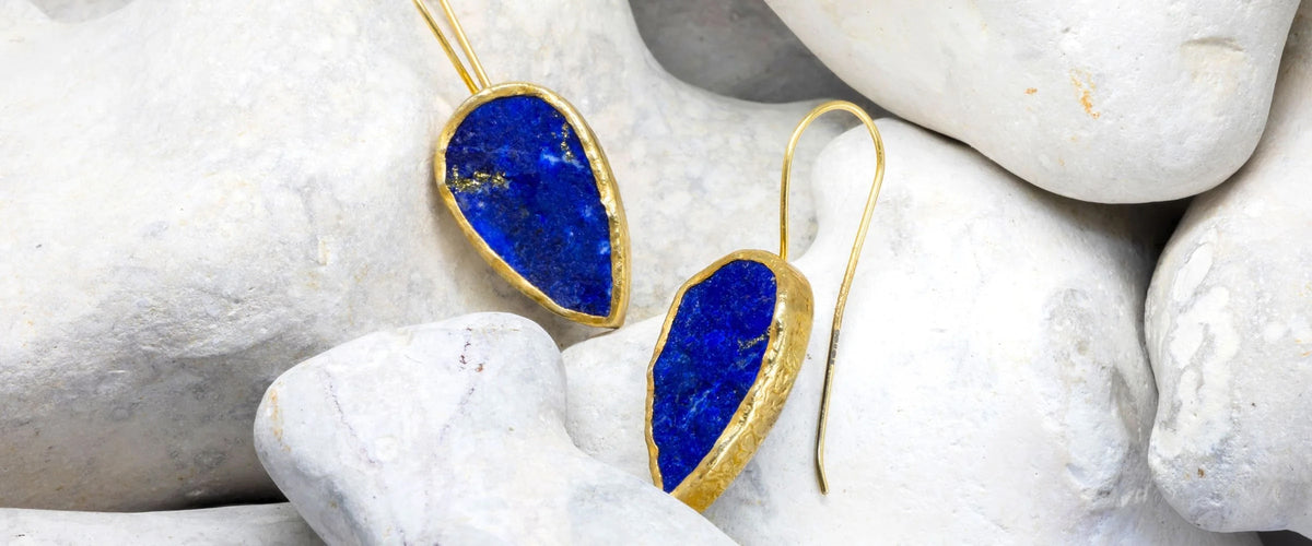 Lapis lazuli drop earrings on a rock background