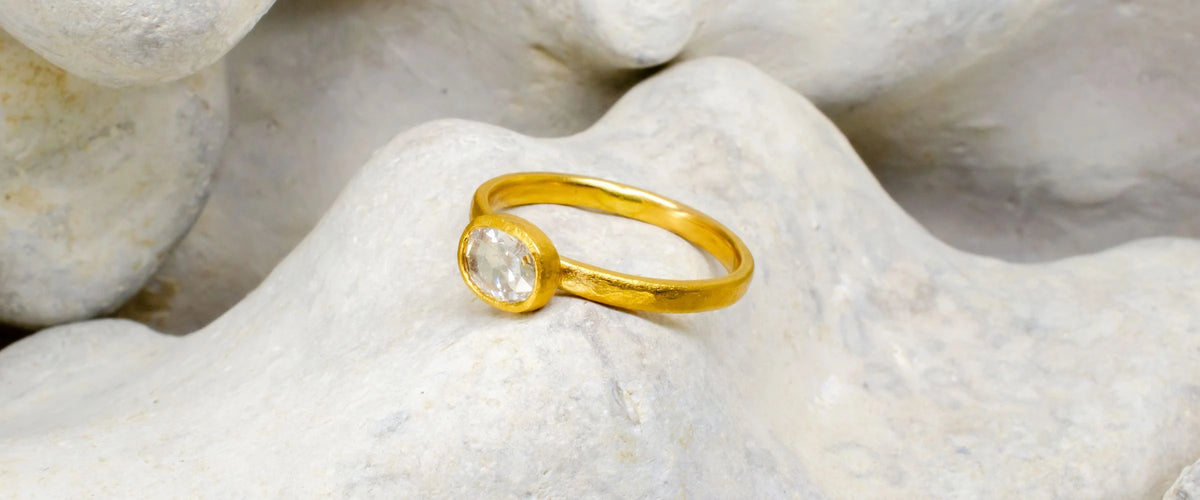 Gold and Diamond Ring on rock background