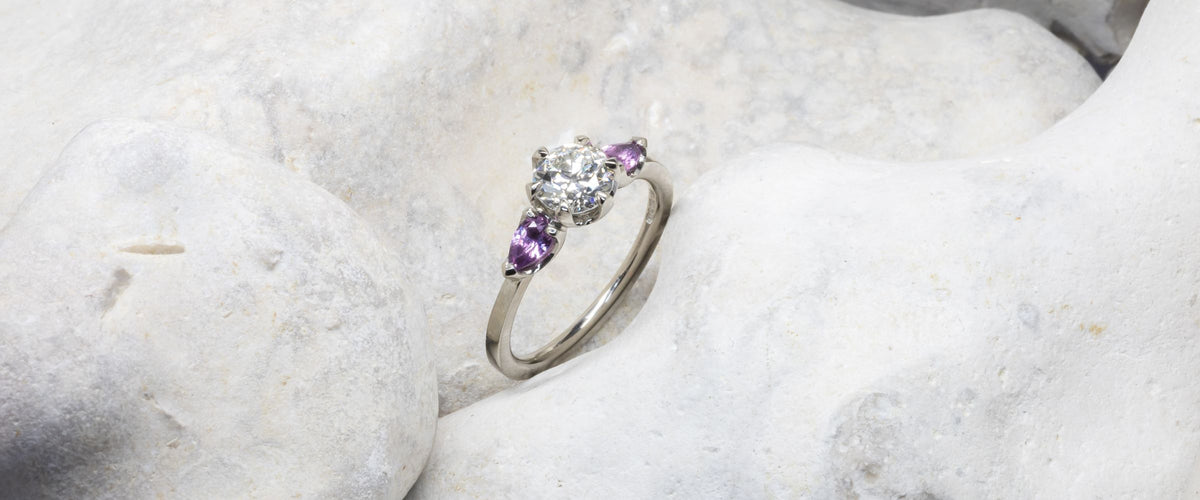 Claw Set engagement ring on stone background