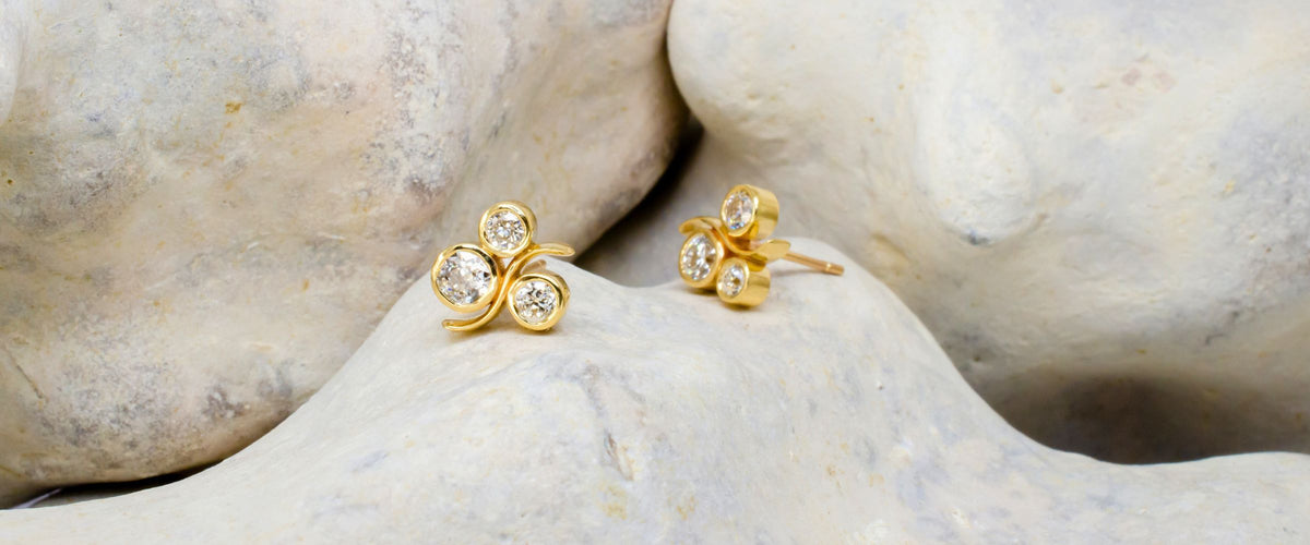Gold and diamond studs on rock background