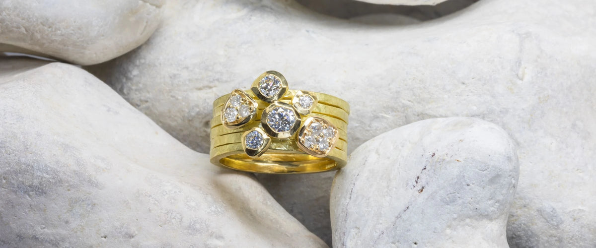 Gold stacking rings on rocks