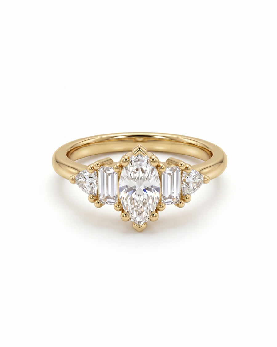 Gold engagement ring with a marquise center stone, baguette side stones, and trillion accents in claw settings.