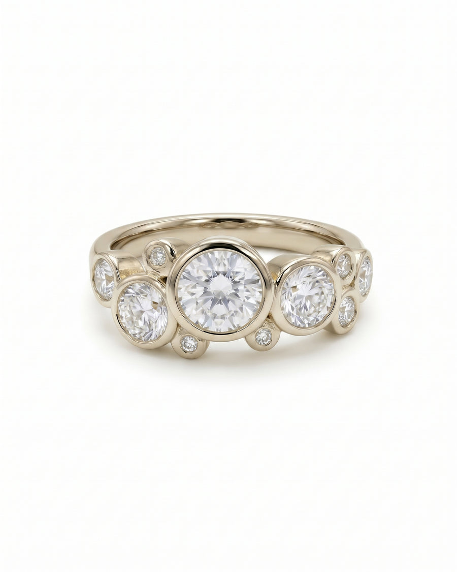 Gold engagement ring featuring multiple round-cut lab-grown diamonds in a bubble-inspired bezel setting.