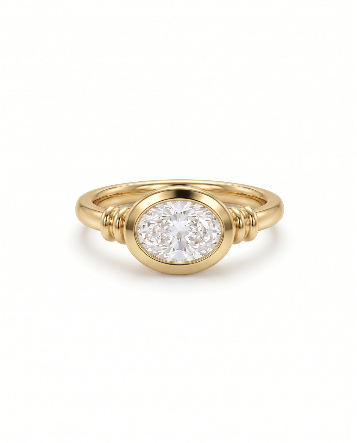 Gold engagement ring featuring an east-west oval diamond in a bezel setting with ribbed band details.