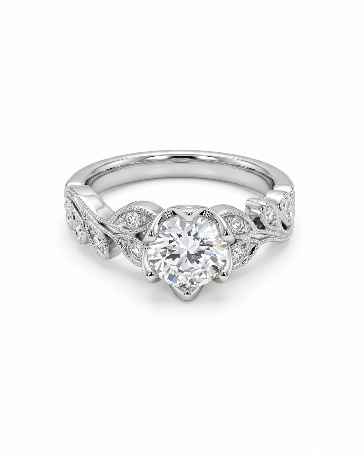 Vintage platinum engagement ring with a round diamond center stone and leaf-inspired diamond side accents.