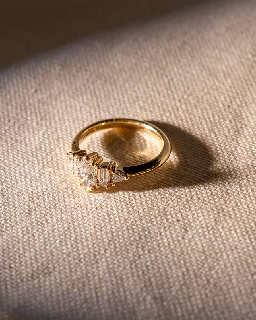Gold engagement ring with marquise and baguette cut diamonds.