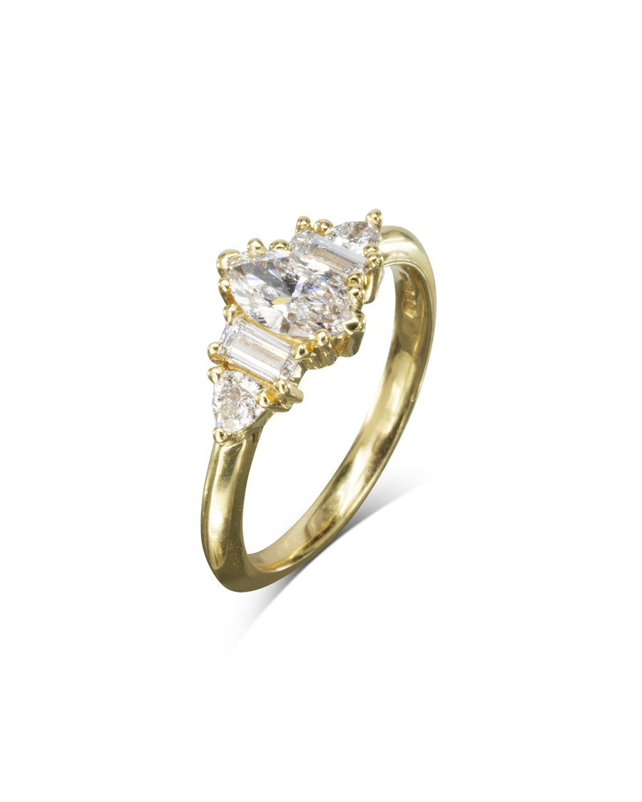 Gold engagement ring with a marquise cut diamond center and claw side stones.