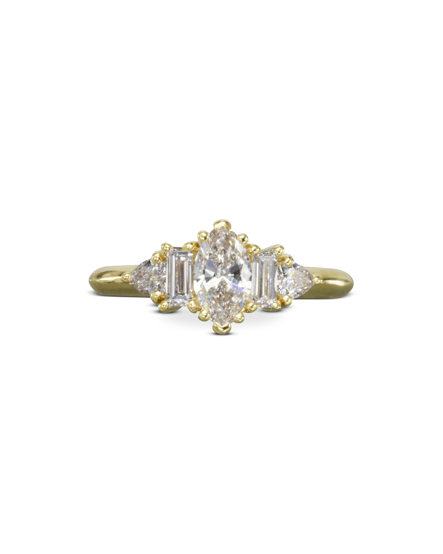 Yellow gold engagement ring with a marquise cut diamond center stone and claw side stones.
