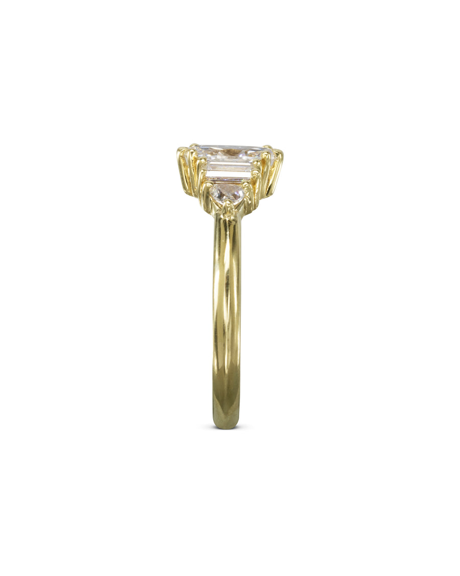 Yellow gold engagement ring with marquise and claw side stones.
