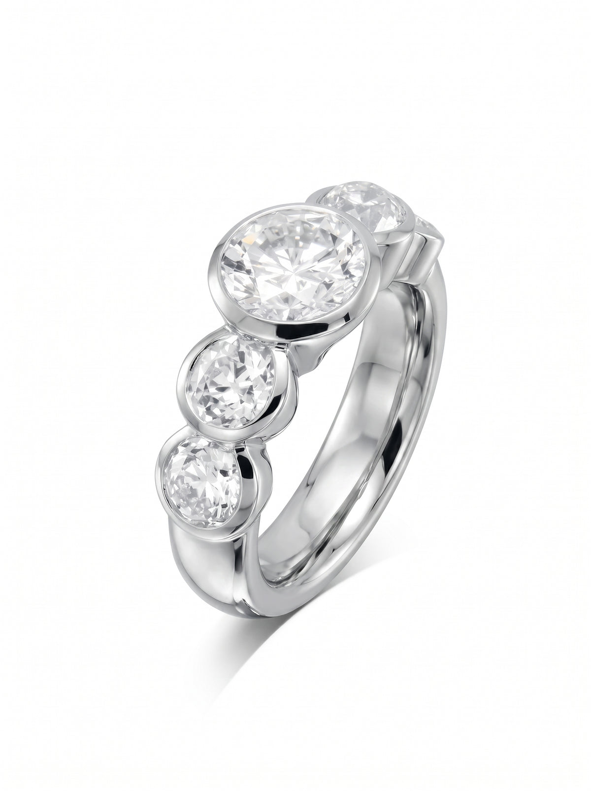 Platinum engagement ring with three round brilliant cut diamonds in a bezel setting.