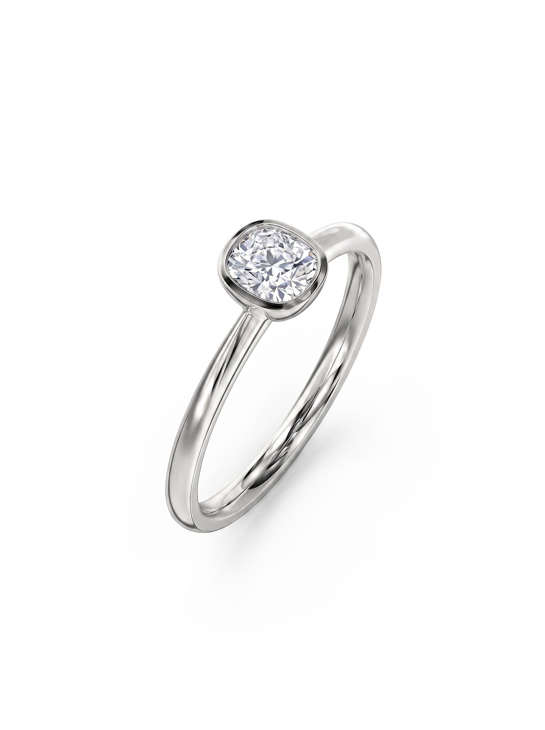 Cushion cut diamond engagement ring in a polished silver-tone bezel setting on a plain metal band.