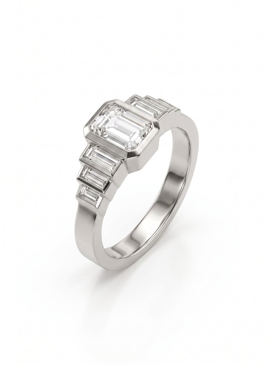 Platinum engagement ring featuring an emerald cut center diamond flanked by three baguette diamonds on each side.
