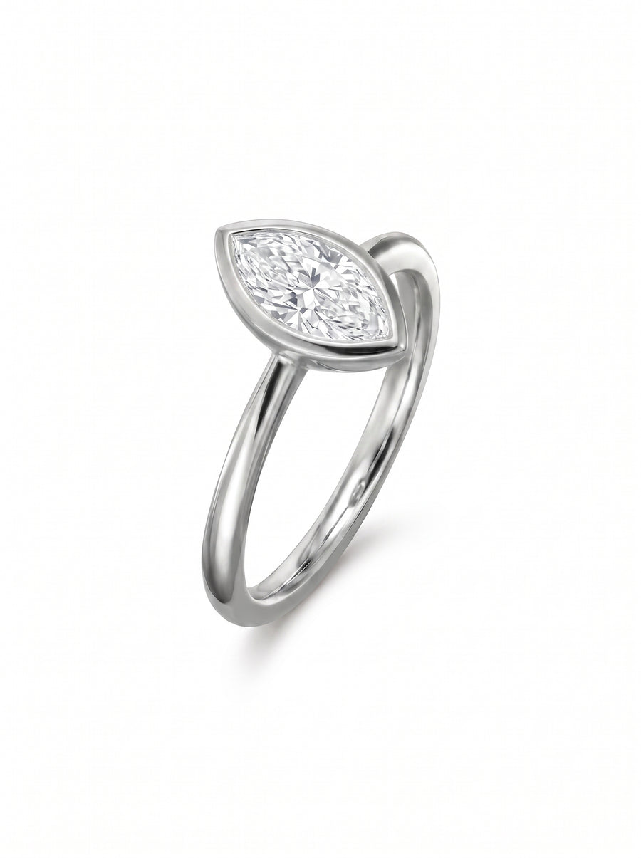 Marquise cut diamond engagement ring in a silver-toned bezel setting on a polished metal band.