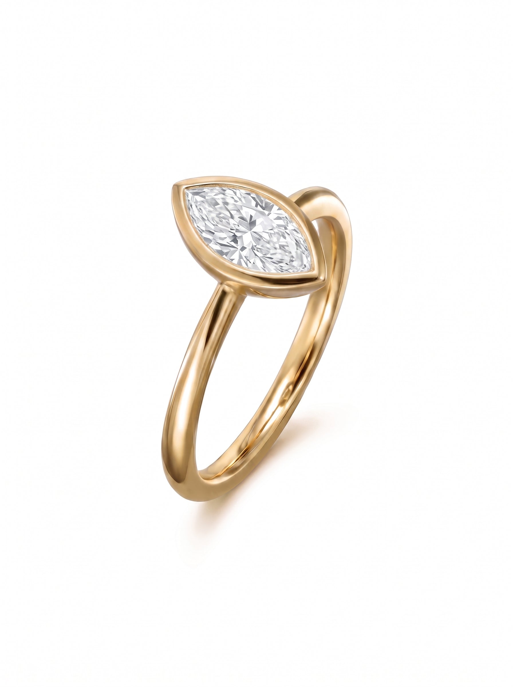 Marquise cut diamond engagement ring in a gold bezel setting on a white background.
