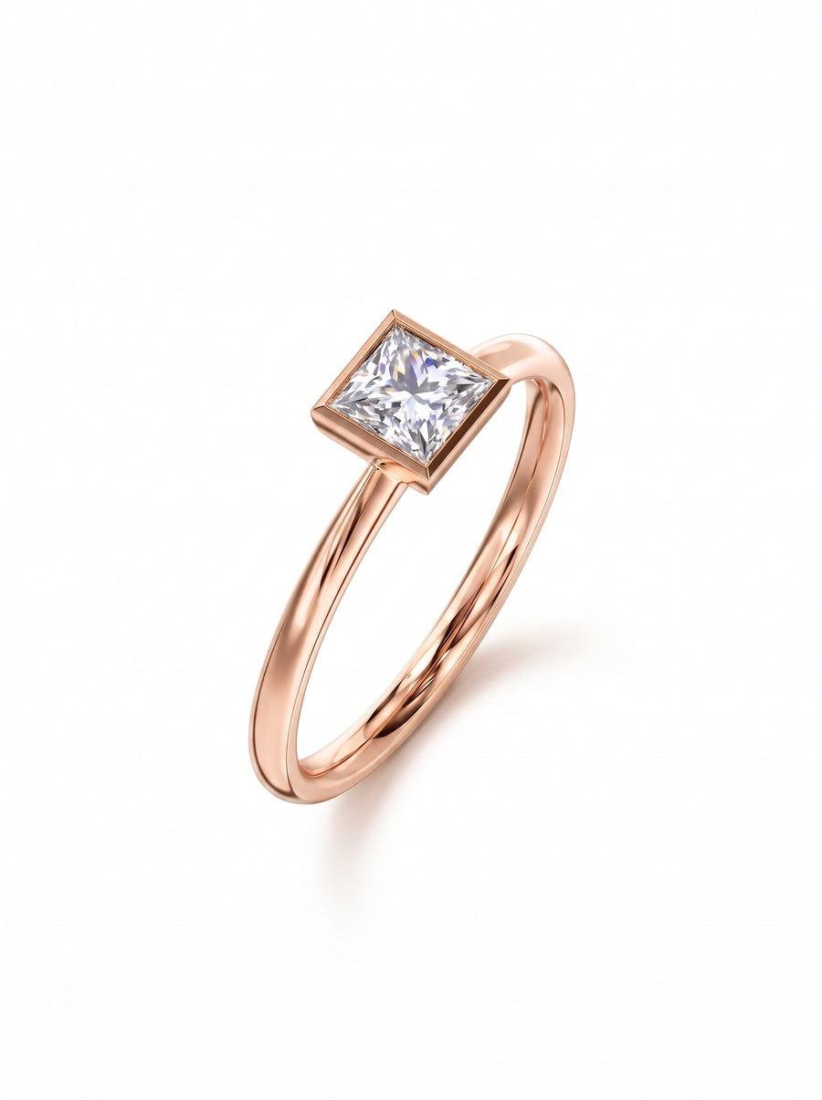 Princess cut diamond engagement ring in a rose gold bezel setting on a white background.