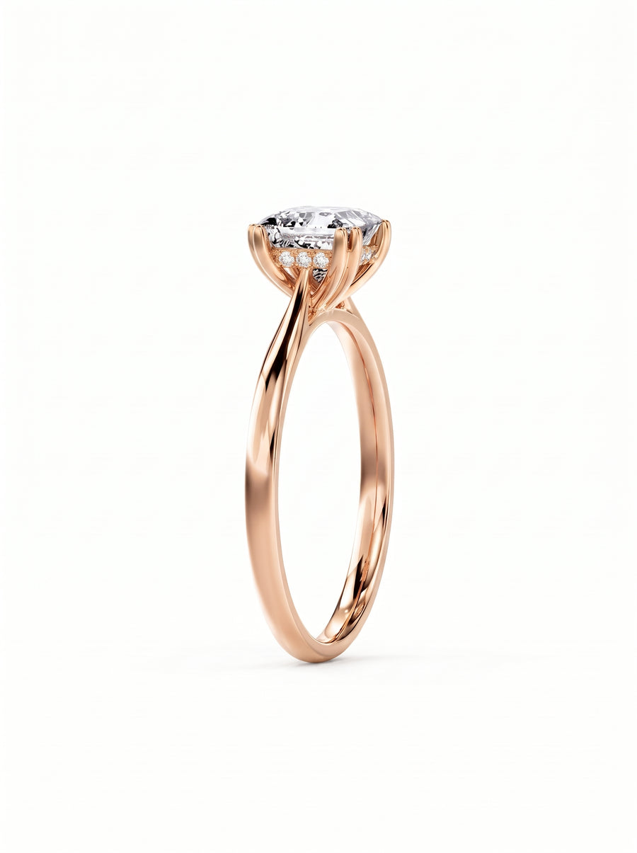 Princess cut diamond engagement ring in rose gold with a hidden halo setting on a plain band.