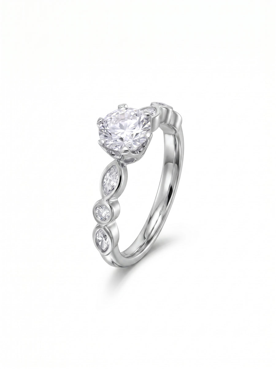 Round cut diamond engagement ring in silver with marquise and round accent stones on a crown setting.