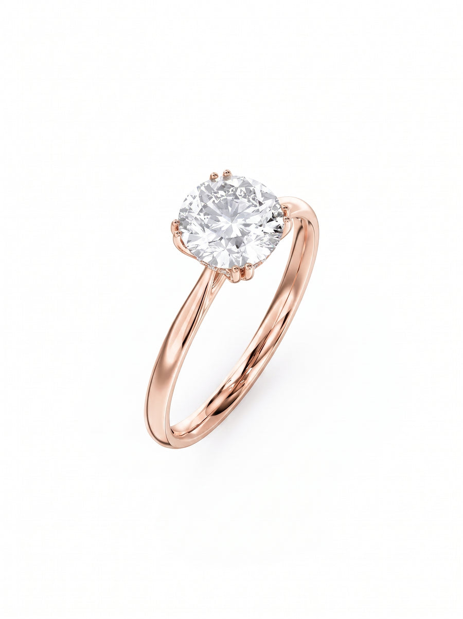 Round cut diamond engagement ring with a hidden halo set in polished rose gold.