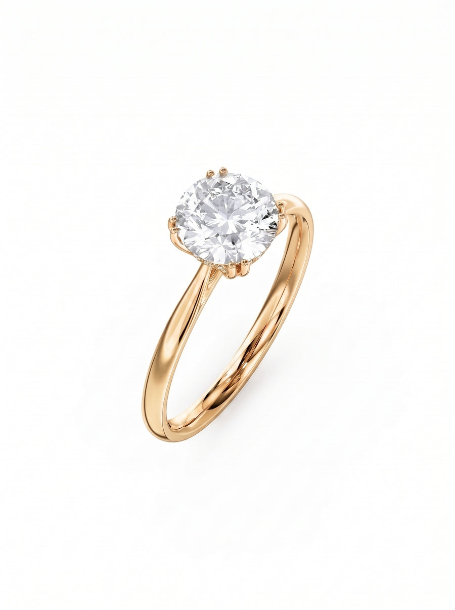 Round cut diamond engagement ring with a hidden halo set in polished yellow gold on a white background.