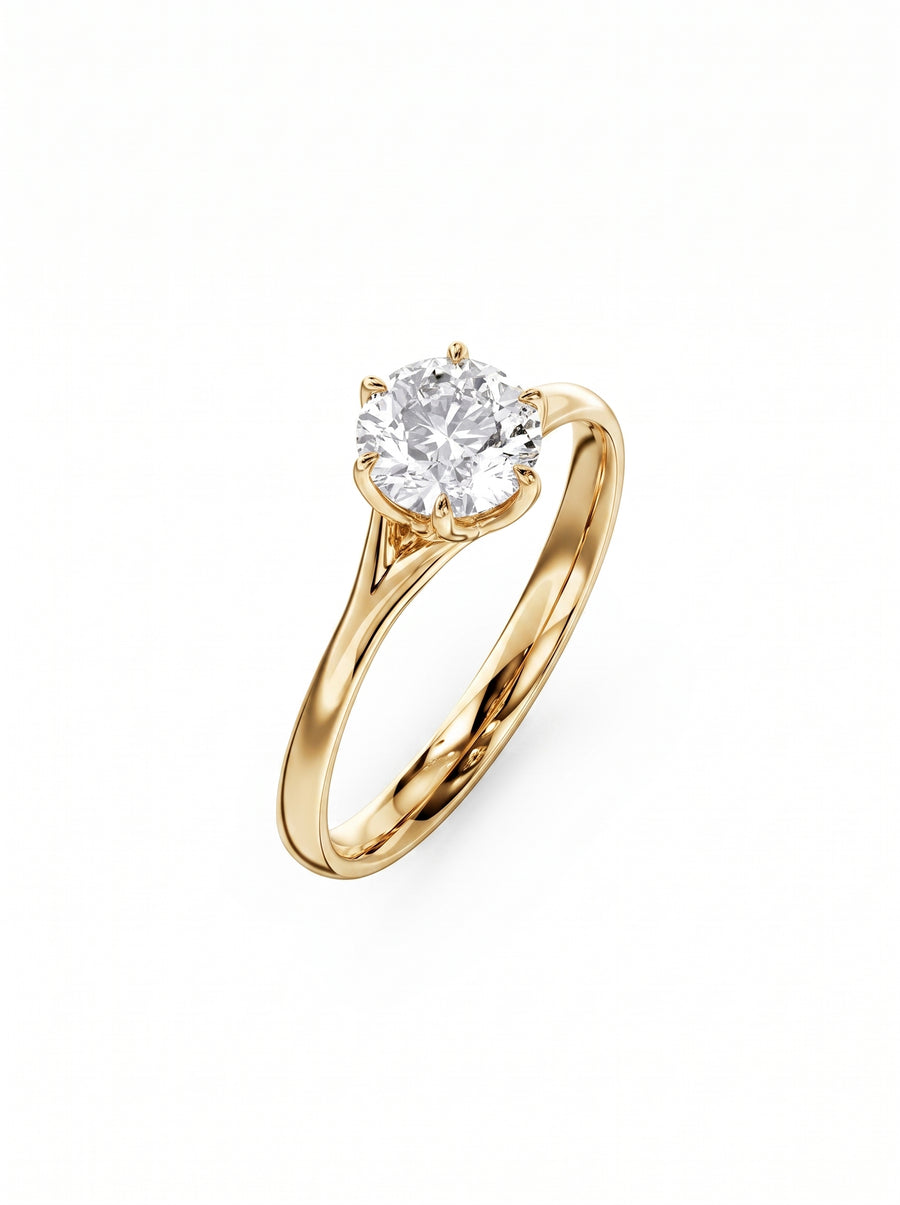 Round cut diamond engagement ring in 18k yellow gold with a six-prong tulip claw setting.