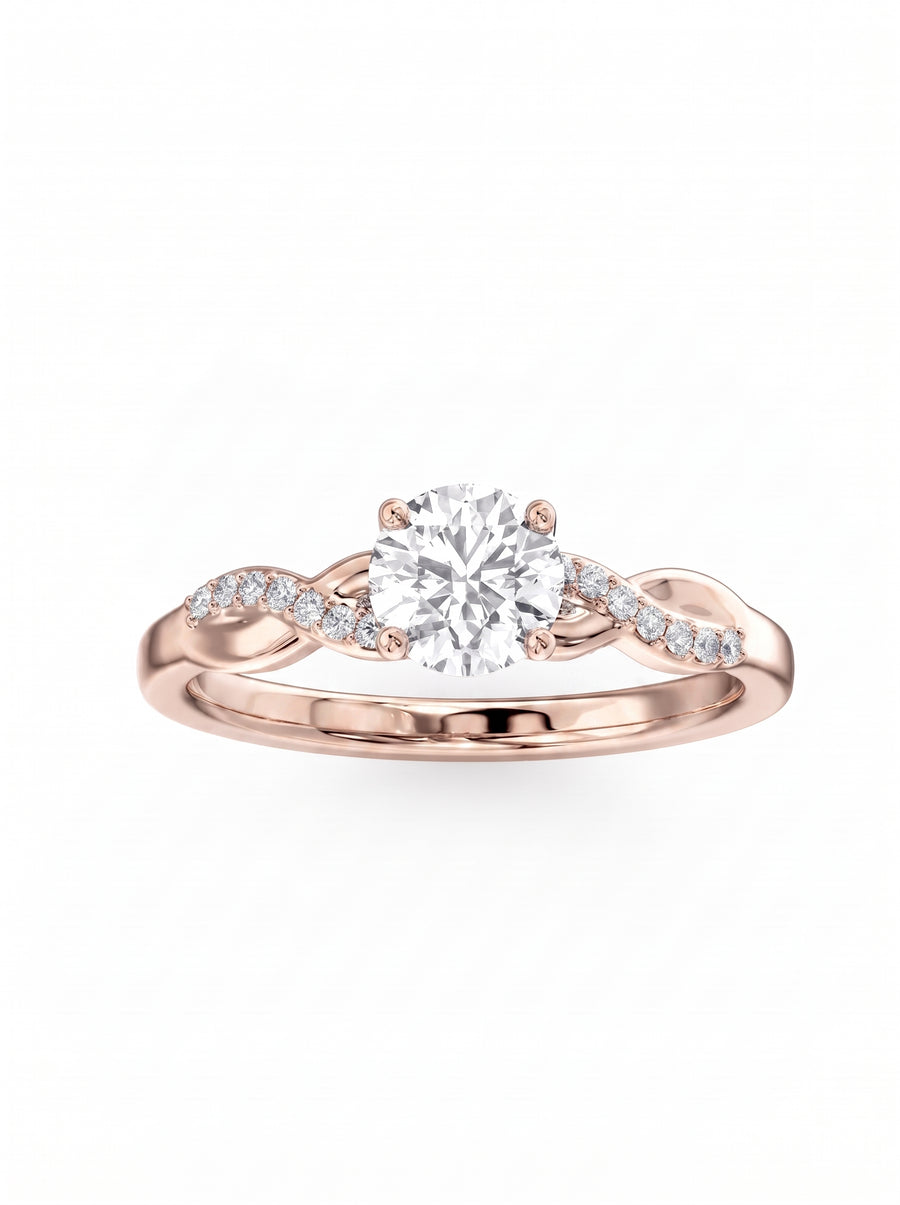 Round cut diamond engagement ring in rose gold with a twisted band and pavé accent stones.