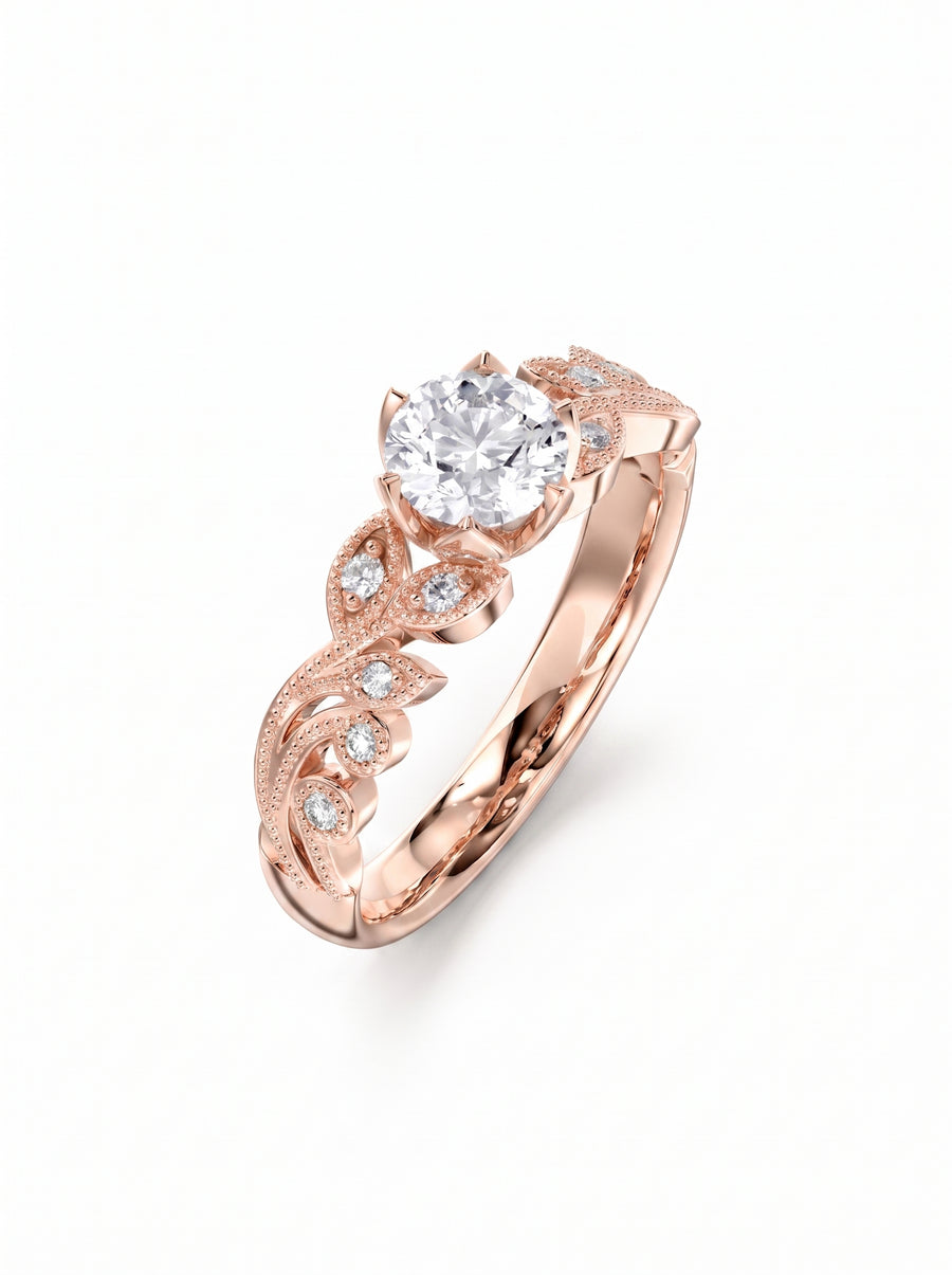 Round cut diamond engagement ring in rose gold with a vintage leaf-inspired band and milgrain detailing.