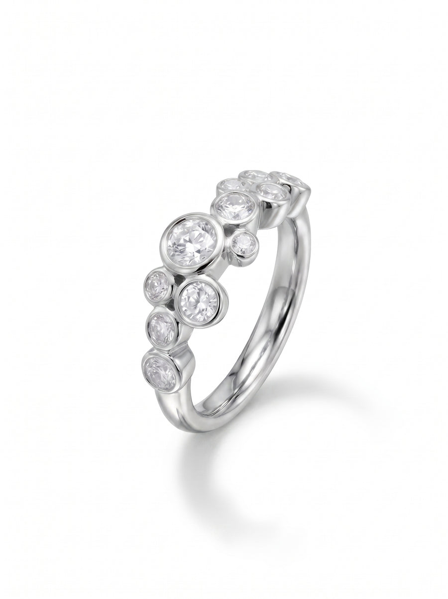 Silver engagement ring with bezel-set round cut diamonds in a cluster bubble design.