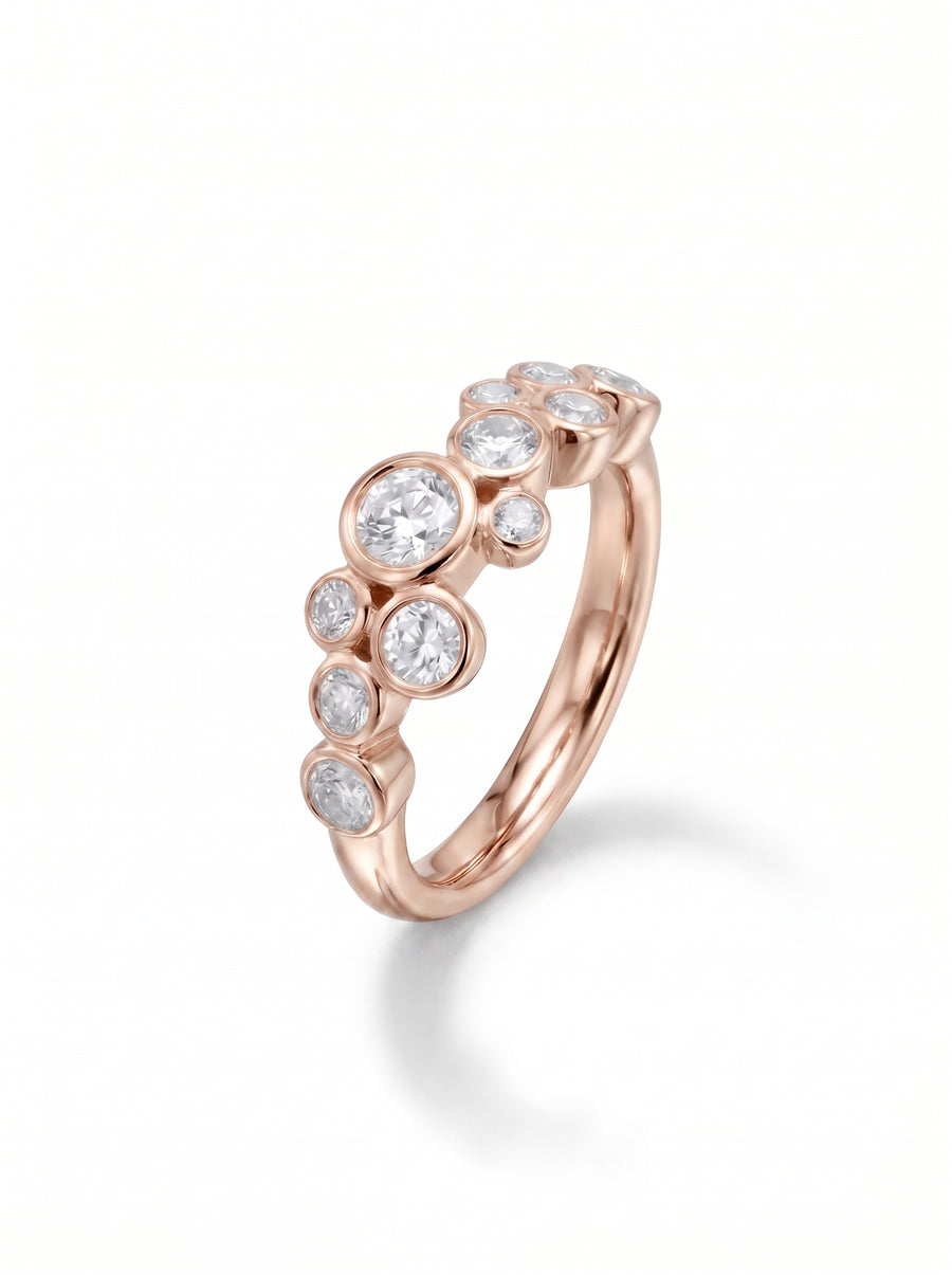 Rose gold ring featuring bezel-set round cut diamonds in a cluster bubble design.