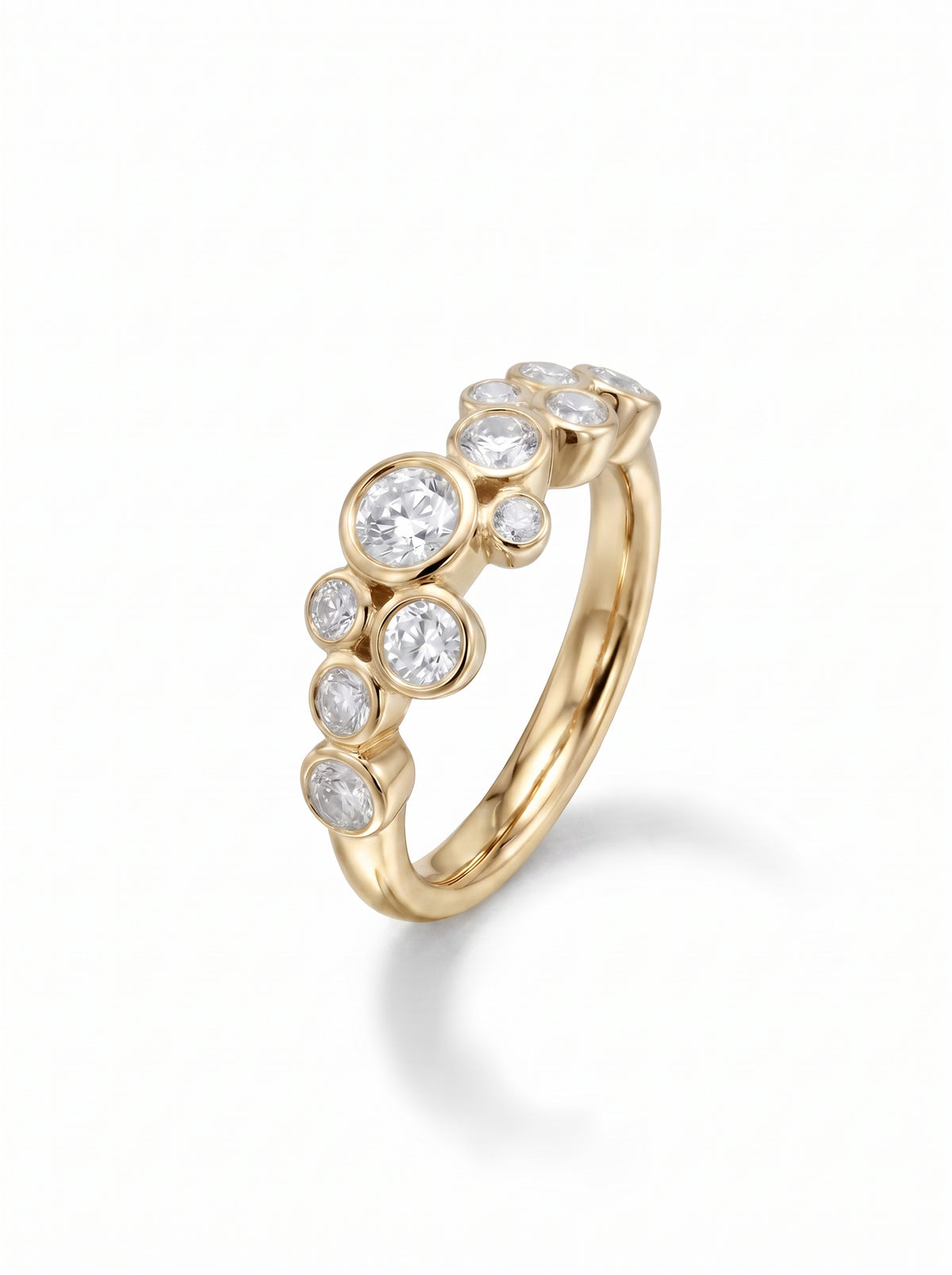 Gold ring with multiple round cut diamonds in a bubble cluster bezel setting.