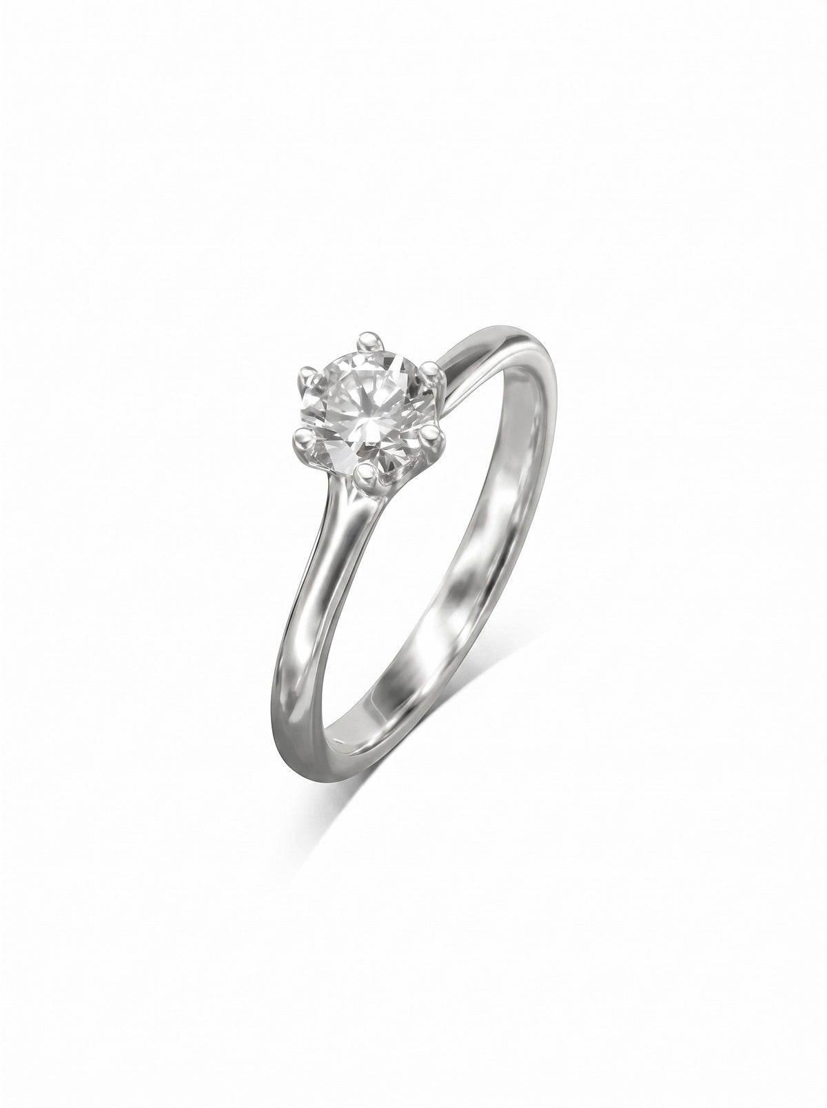 Round diamond solitaire engagement ring in a silver-toned metal with a six-claw v-setting.