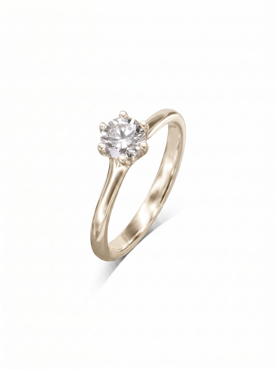 Round diamond solitaire engagement ring in a six-claw v-setting on a polished yellow gold band.