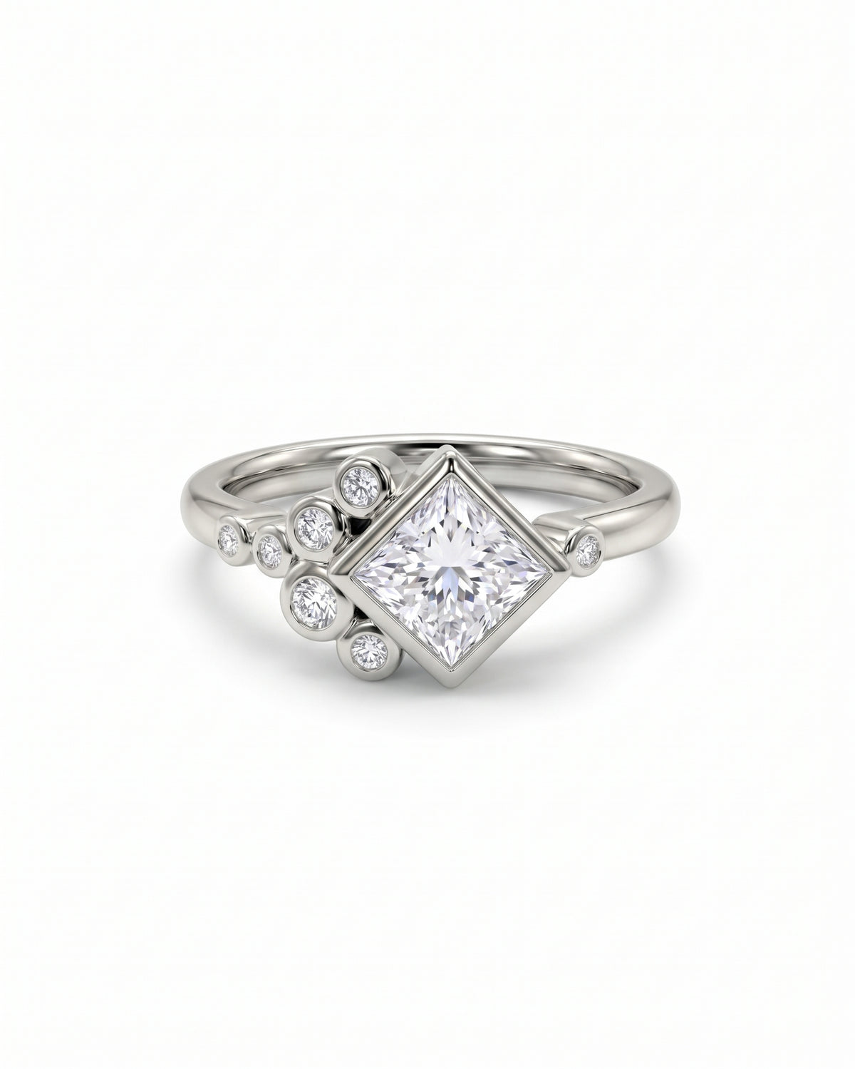 Princess cut diamond engagement ring in silver metal with a cluster of round accent stones.