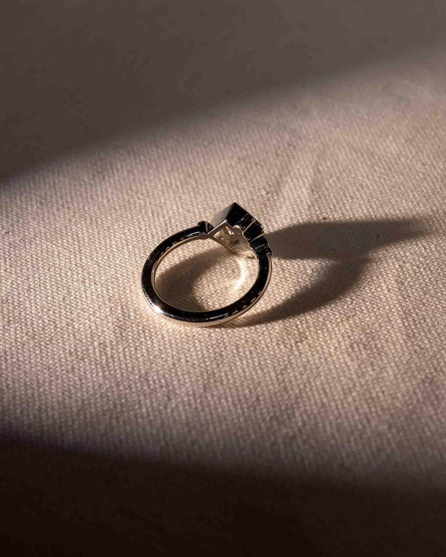 Platinum ring with an emerald cut lab-grown diamond.