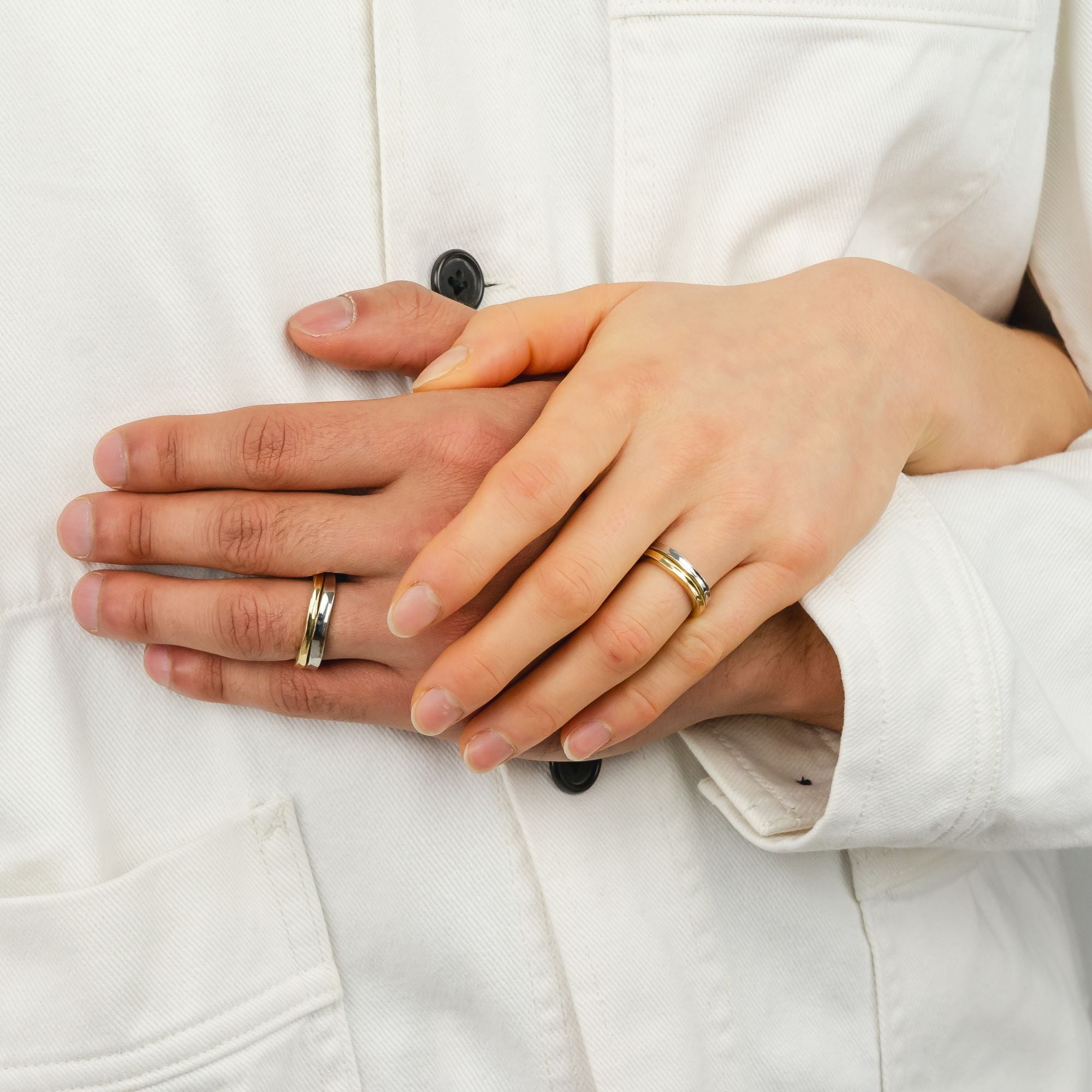 Holding hands with handmade wedding rings