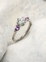 Claw set engagement ring with amethyst shoulders