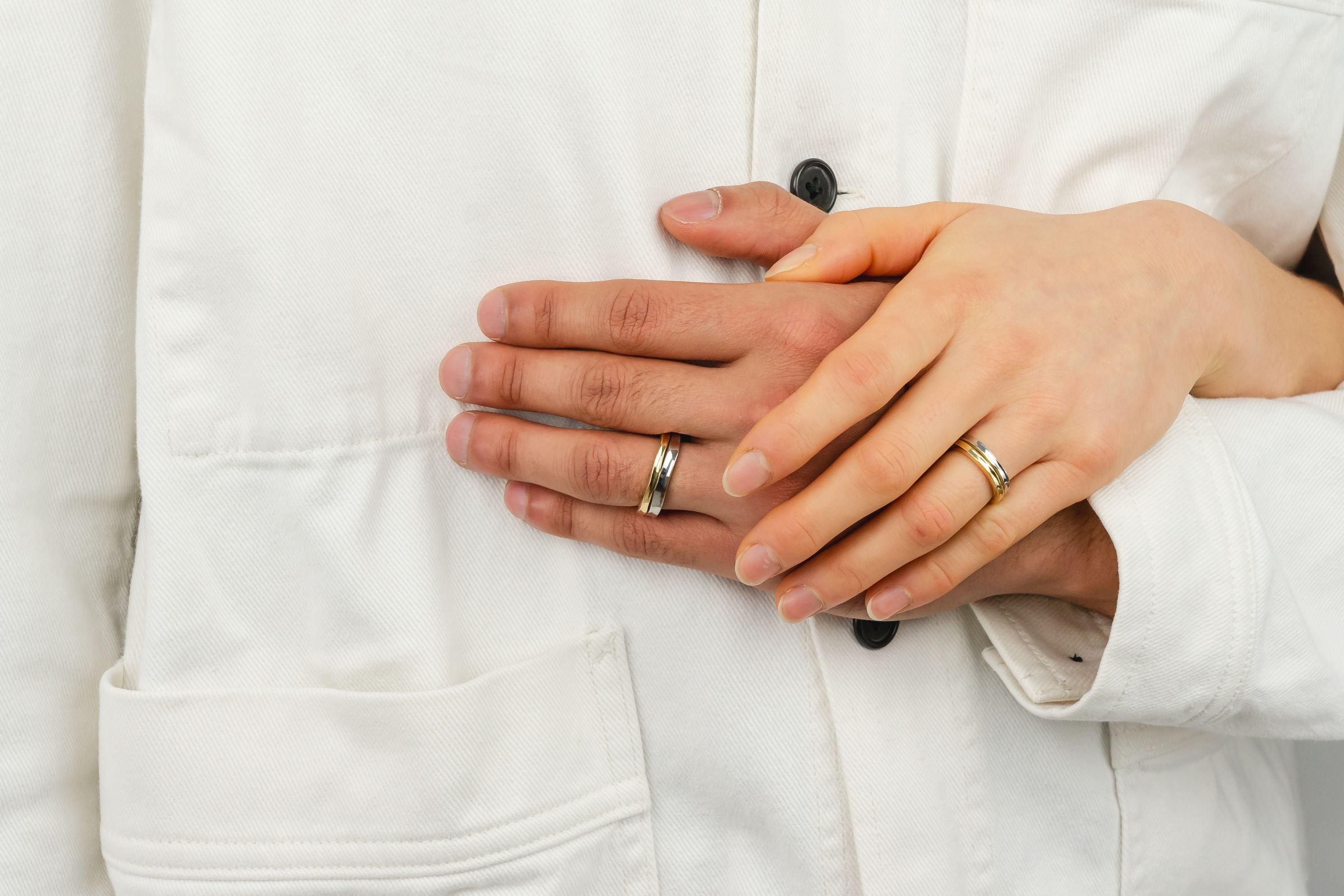 Holding hands with handmade wedding rings