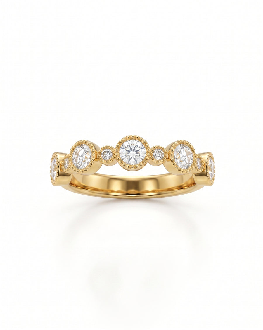 Gold eternity ring with alternating round diamonds in bezel settings.