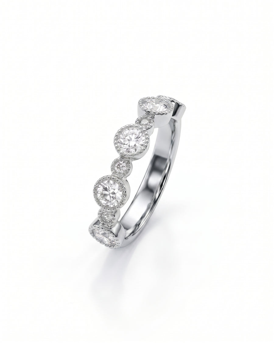 Gold eternity ring with alternating round diamonds in bezel settings.