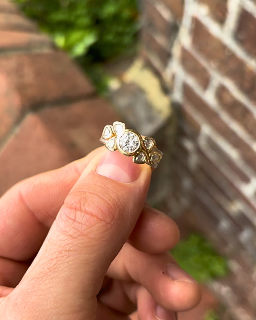 Platinum and 18ct yellow gold engagement ring featuring a round brilliant diamond and rough diamond accents.