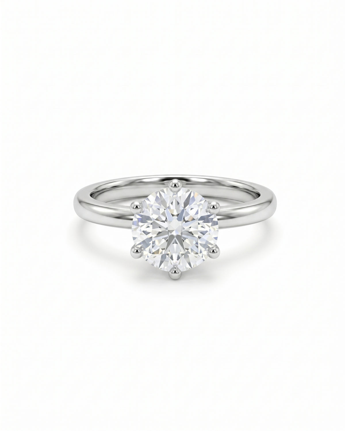 Round cut diamond solitaire engagement ring in a silver-toned metal band with a six-claw setting.