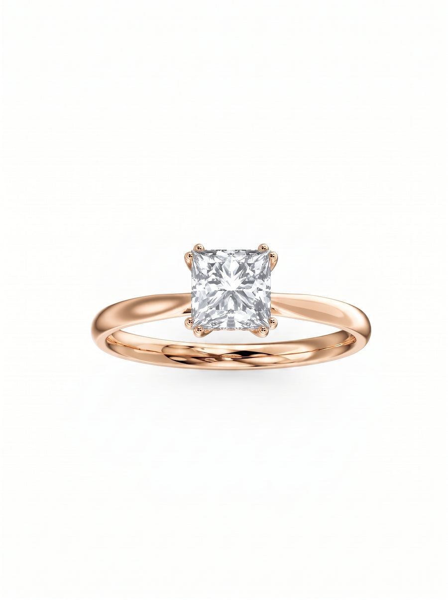Princess cut diamond engagement ring with a hidden halo set in a polished rose gold band.