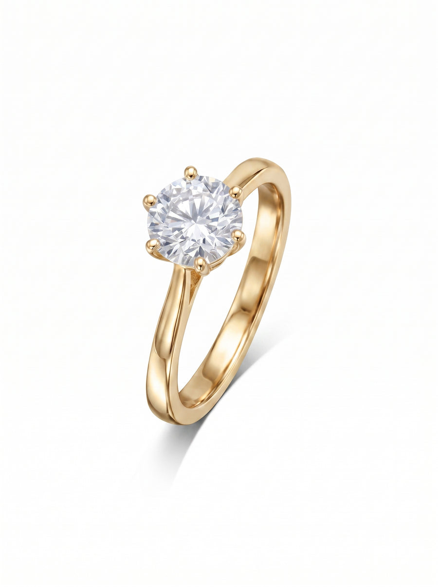 Gold engagement ring with a round brilliant cut diamond held in a six-claw setting.