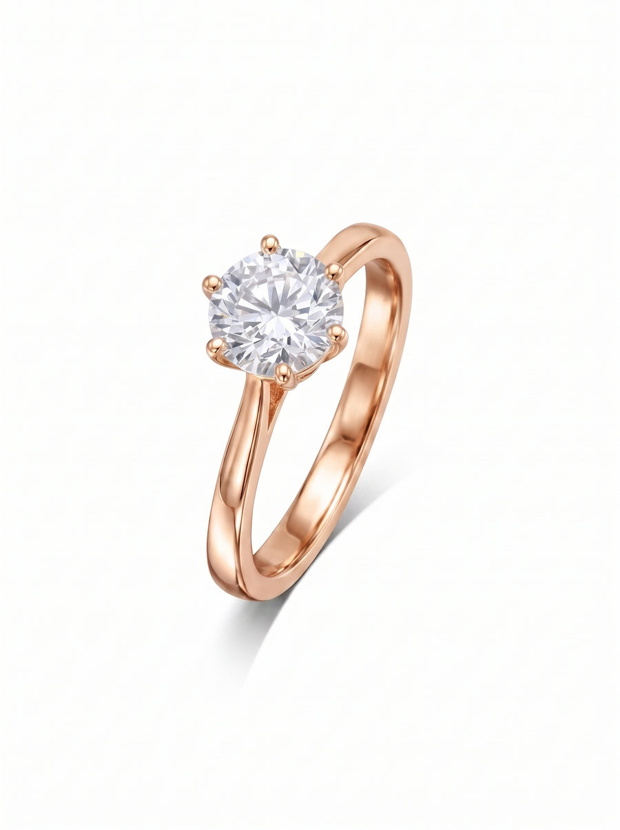 Round brilliant cut diamond engagement ring set in a six-claw rose gold band.