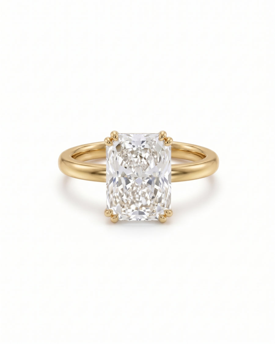 Radiant cut lab-grown diamond engagement ring with a hidden halo set in a yellow gold band.