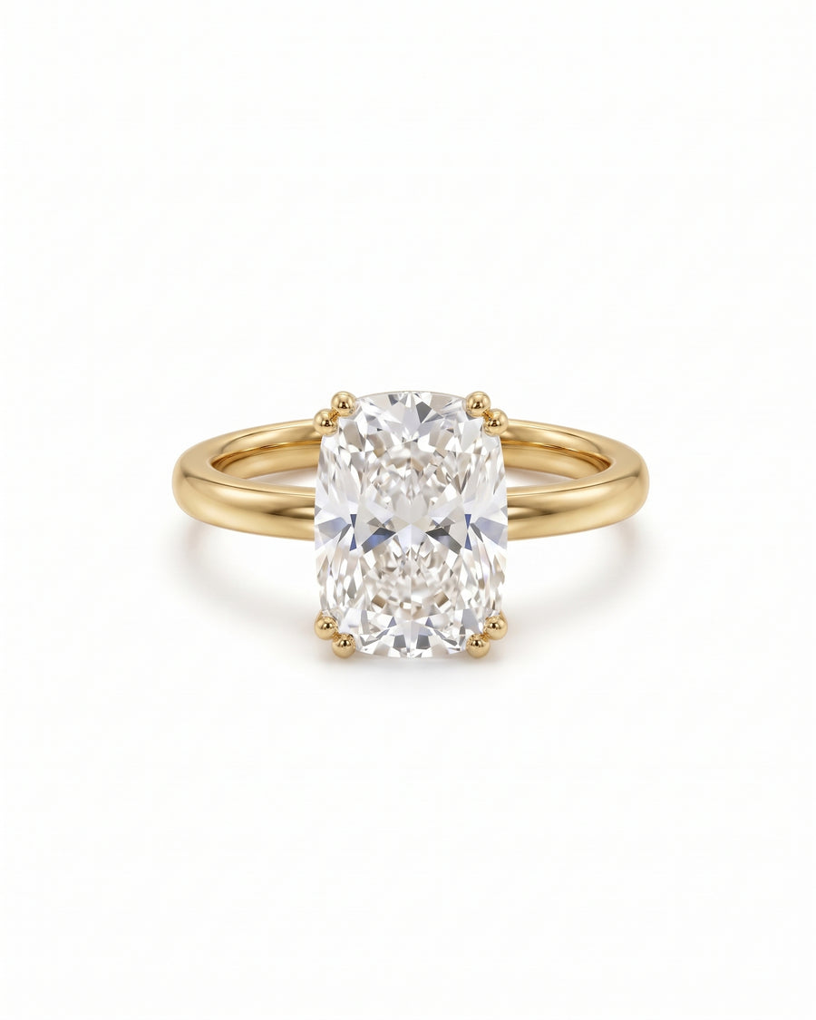 1.5ct cushion cut lab-grown diamond engagement ring with a hidden halo set in polished yellow gold.