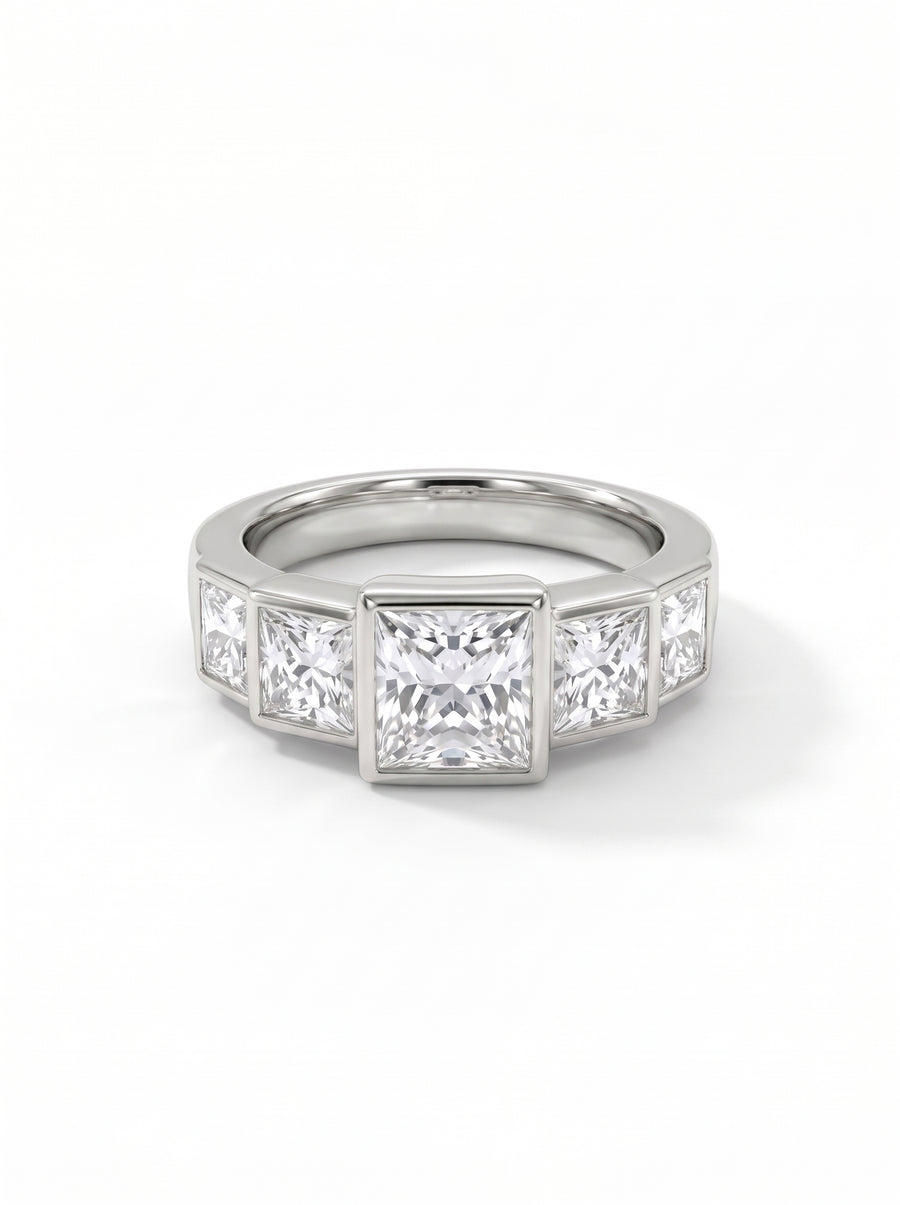 Five princess cut diamonds set in a silver band with a bezel setting.