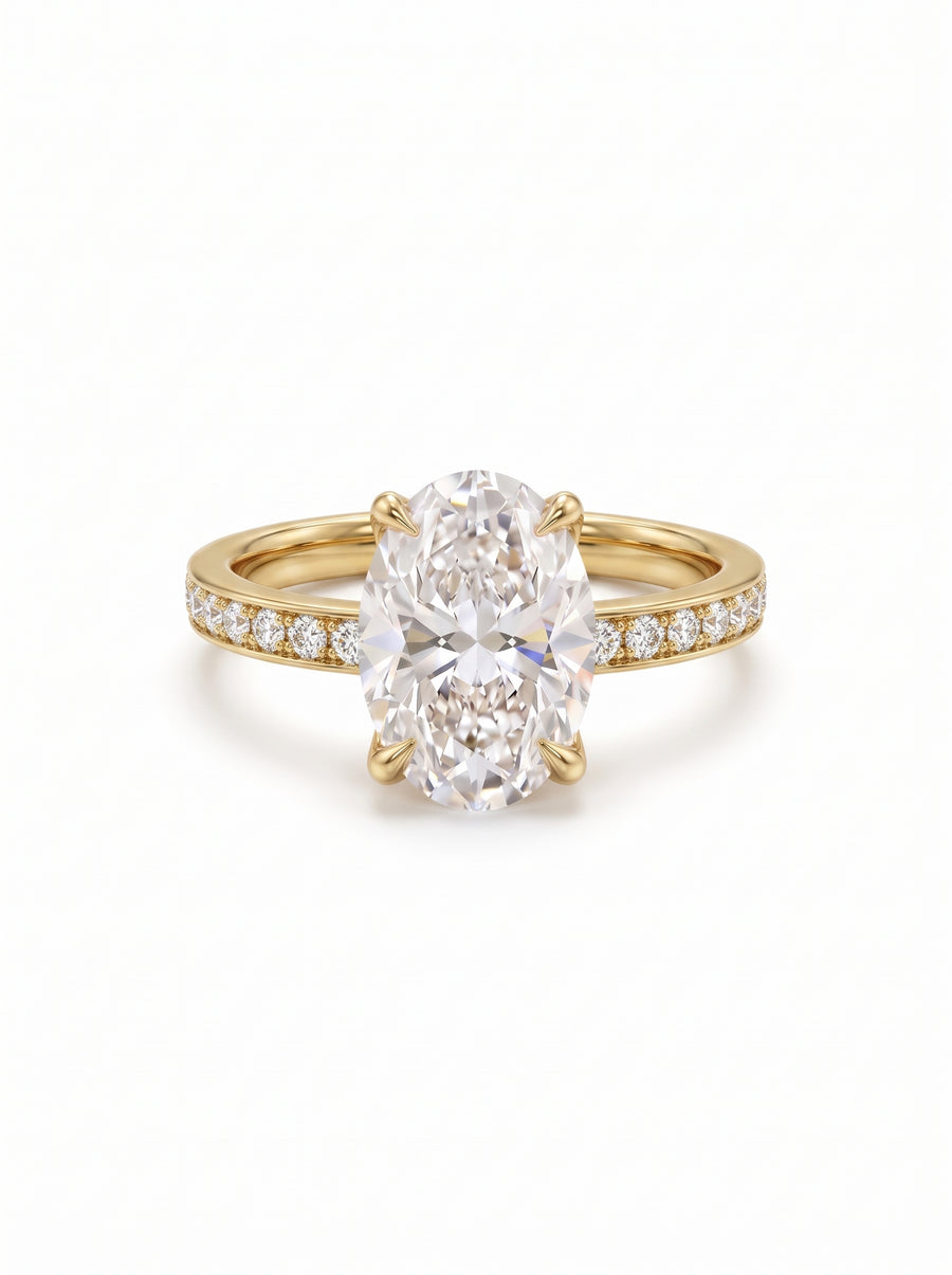 Oval lab-grown diamond engagement ring in 14k yellow gold with a pavé diamond band.